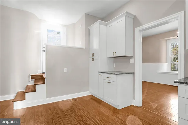 a view of a kitchen with wooden floor