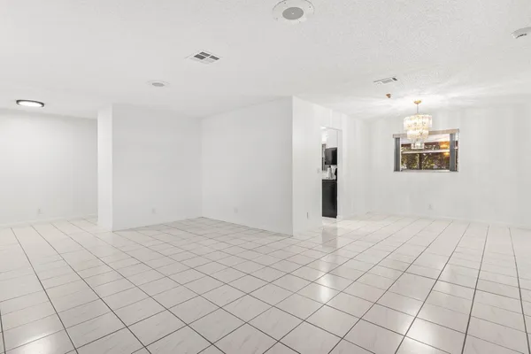 an empty room with windows and cabinet