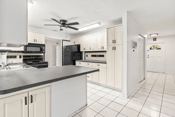 a kitchen with stainless steel appliances a refrigerator and a stove top oven