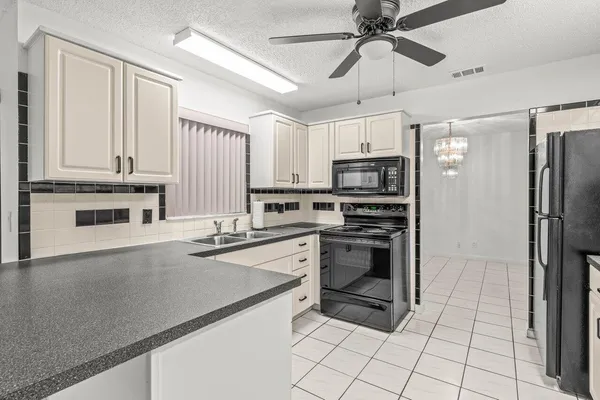 a kitchen with stainless steel appliances a stove a sink and a refrigerator
