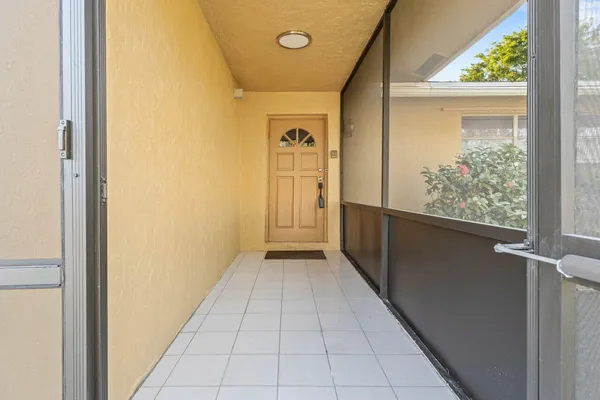 a view of a hallway with wooden floor and a corridor