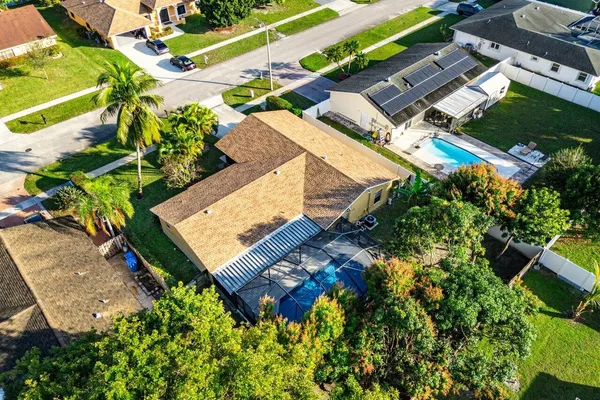 an aerial view of a house with a yard