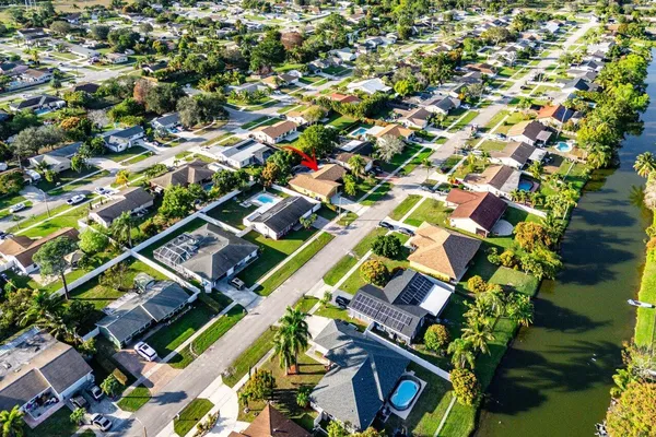 an aerial view of a residential apartment building with a yard and plants