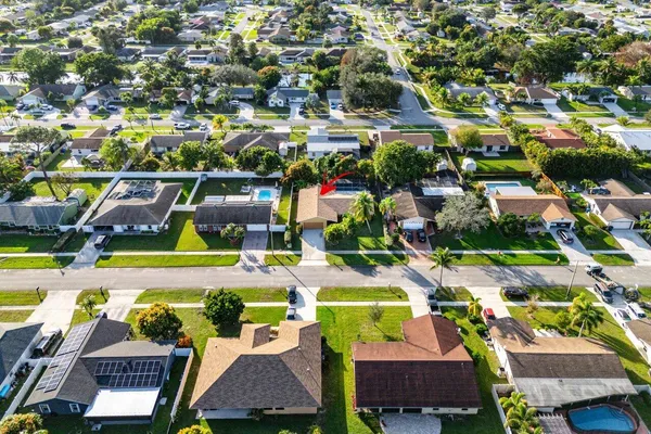 an aerial view of residential houses and car parked on street side
