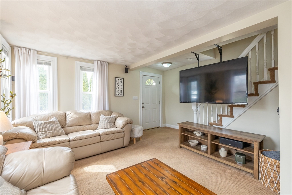 12 Post Road North Billerica, MA 01862 - Photo 19 of 38 a living room with furniture and a flat screen tv
