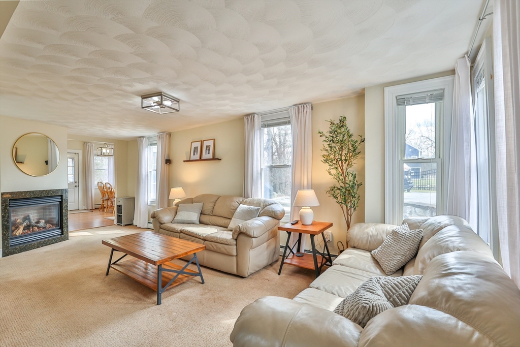 12 Post Road North Billerica, MA 01862 - Photo 20 of 38 a living room with furniture fireplace and a window