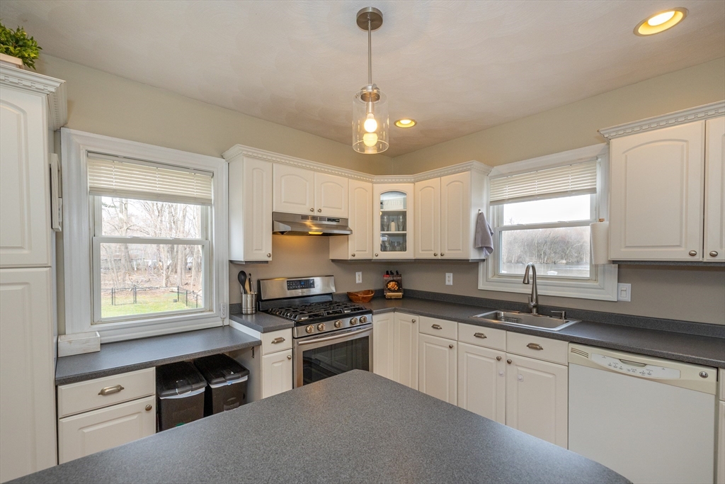 12 Post Road North Billerica, MA 01862 - Photo 2 of 38 a kitchen with stainless steel appliances white cabinets a sink a stove a refrigerator and cabinets