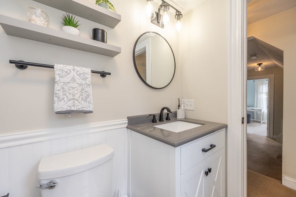 12 Post Road North Billerica, MA 01862 - Photo 26 of 38 a bathroom with a granite countertop sink and a mirror