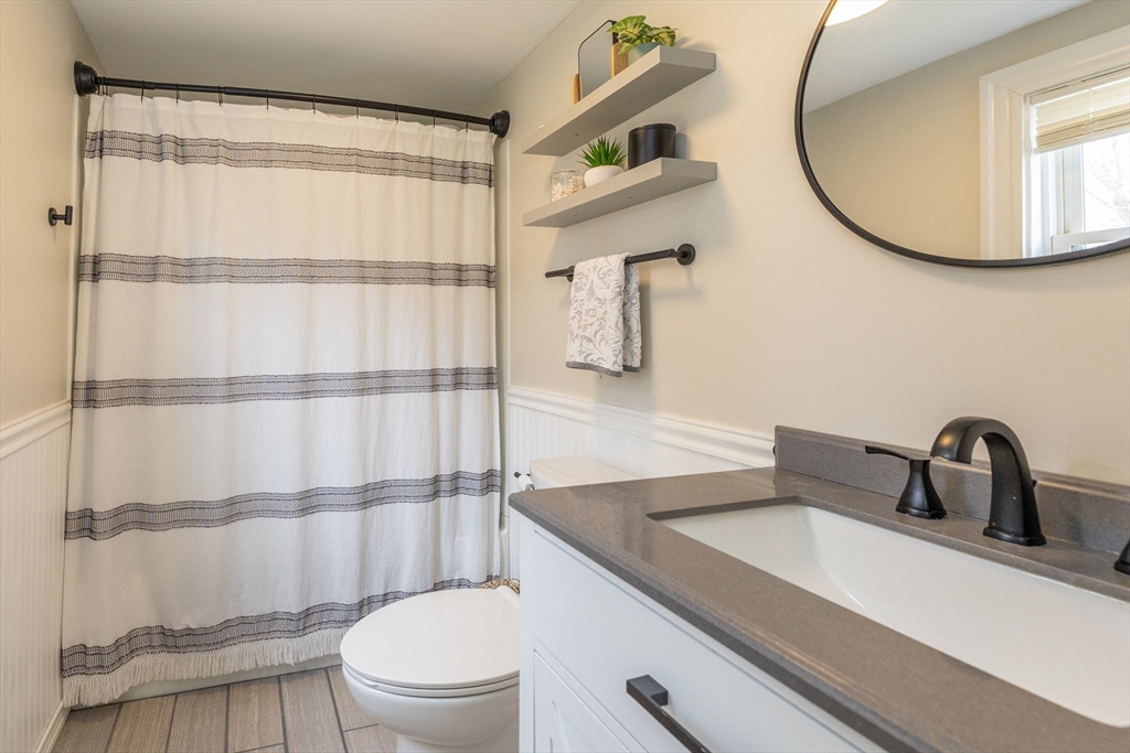 12 Post Road North Billerica, MA 01862 - Photo 27 of 38 a bathroom with a sink a toilet and a mirror
