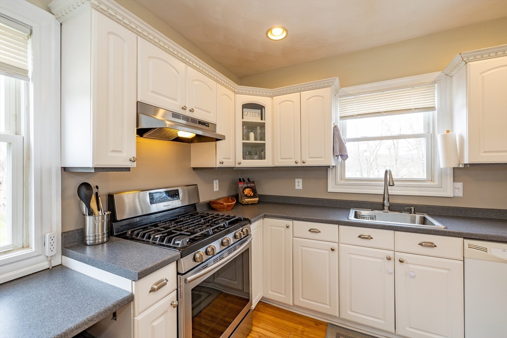 12 Post Road North Billerica, MA 01862 - Photo 3 of 38 a kitchen with granite countertop a sink a stove and cabinets
