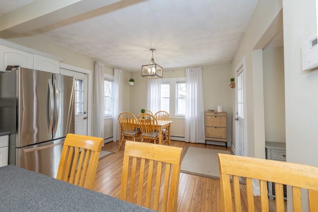 12 Post Road North Billerica, MA 01862 - Photo 7 of 38 a view of a dining room with furniture a chandelier and wooden floor