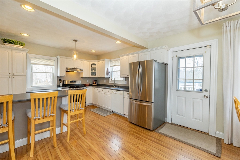 12 Post Road North Billerica, MA 01862 - Photo 8 of 38 a kitchen with stainless steel appliances a refrigerator and wooden floor