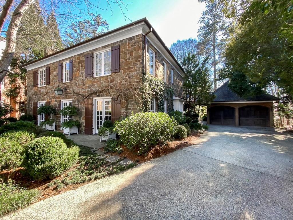 Undisclosed Address Atlanta, GA 30327 - Photo 1 of 1 a front view of a house with a yard and trees