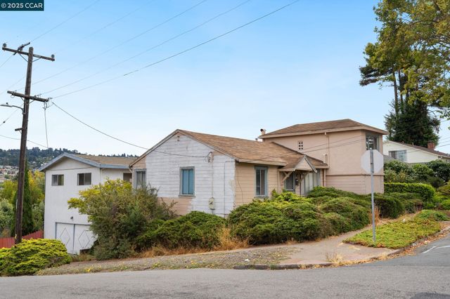 a view of a white house next to a yard