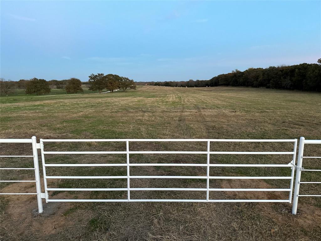 View of entry gate featuring a view of rural / pastoral area
