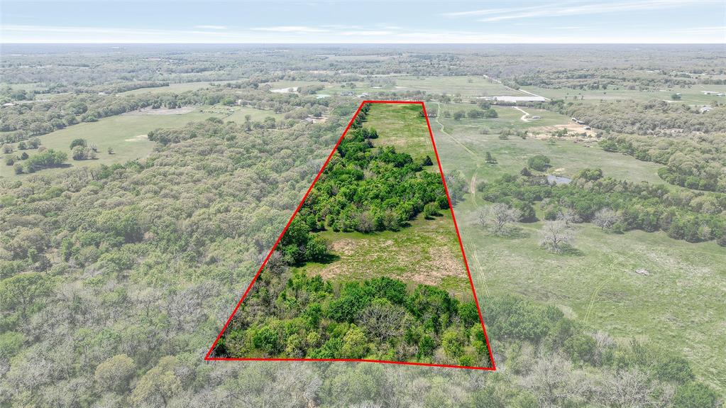 Tbd West Tbd W Line Road Collinsville, TX 76233 - Photo 3 of 16 Aerial view of sparsely populated area featuring property parcel outlined and a heavily wooded area - - boundary lines are approximate