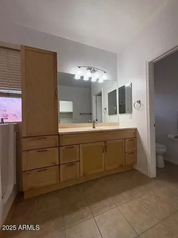 a bathroom with a tub sink and mirror