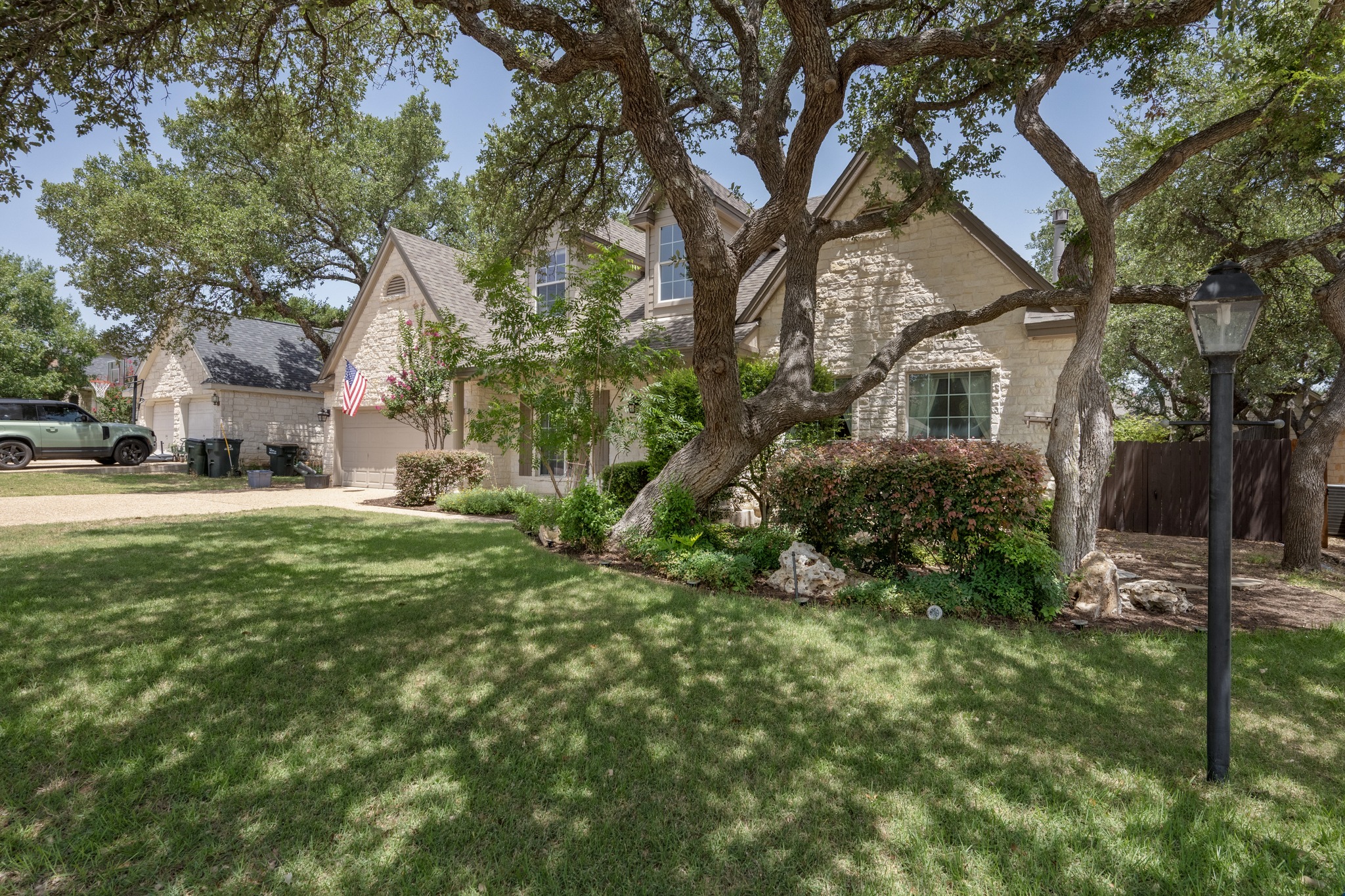 108 Thornwood Road Georgetown, TX 78628 - Photo 2 of 40 Mature trees shade this charming residence with stone construction and a welcoming front yard.