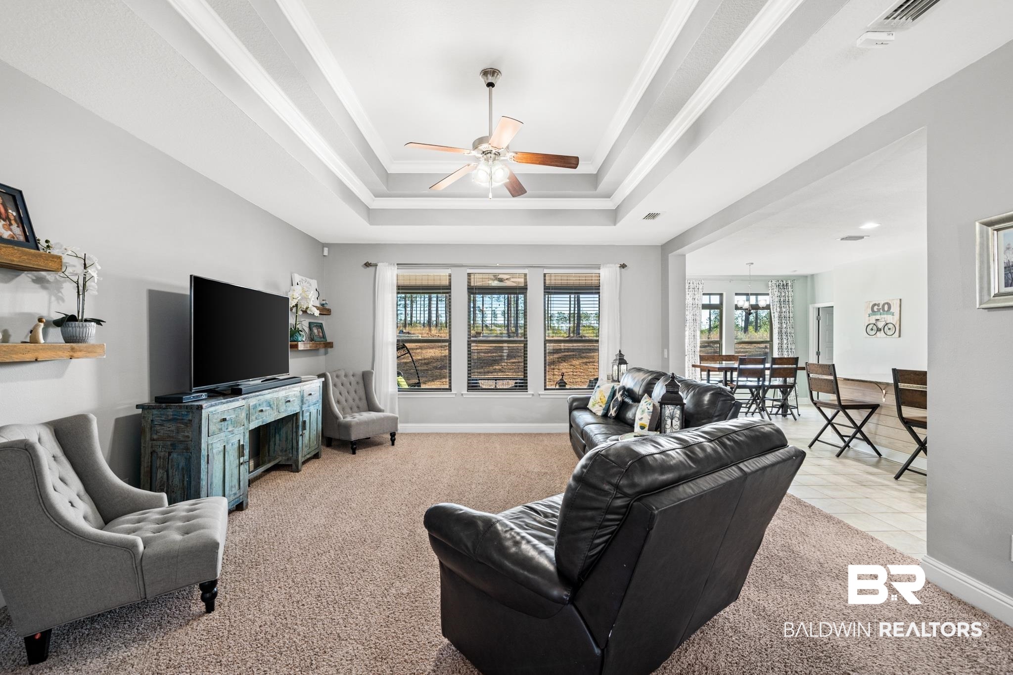 31472 Hoot Owl Road Daphne, AL 36527 - Photo 4 of 32 Living room with a tray ceiling, crown molding, light carpet, and ceiling fan