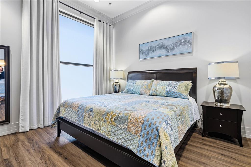 3040 Peachtree Road Northwest, Unit 1503 Atlanta, GA 30305 - Photo 36 of 38 a bedroom with a bed and a night stand