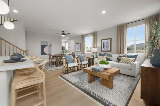 a living room with lots of furniture and a large window