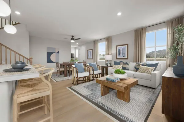 a living room with lots of furniture and a large window