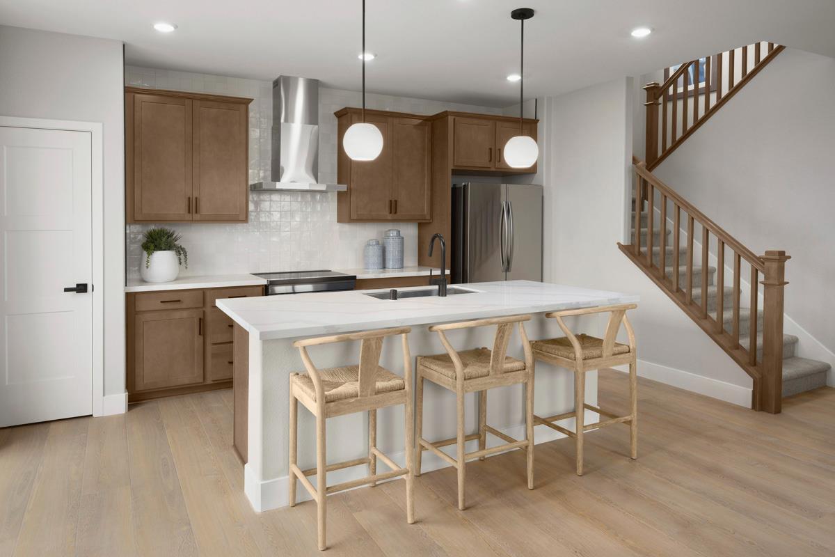 1122 Bengal Loop Rocklin, CA 95765 - Photo 4 of 7 a kitchen with a dining table chairs sink and cabinets