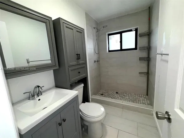 an empty room with windows and entrance