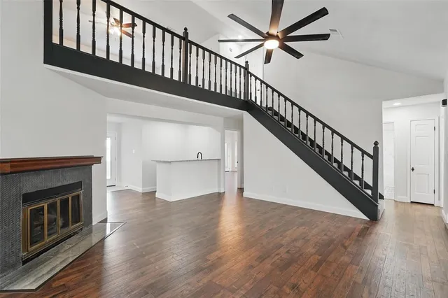 a view of staircase with wooden floor and a fireplace