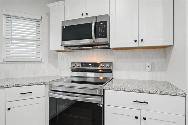 a kitchen with a stove and a microwave