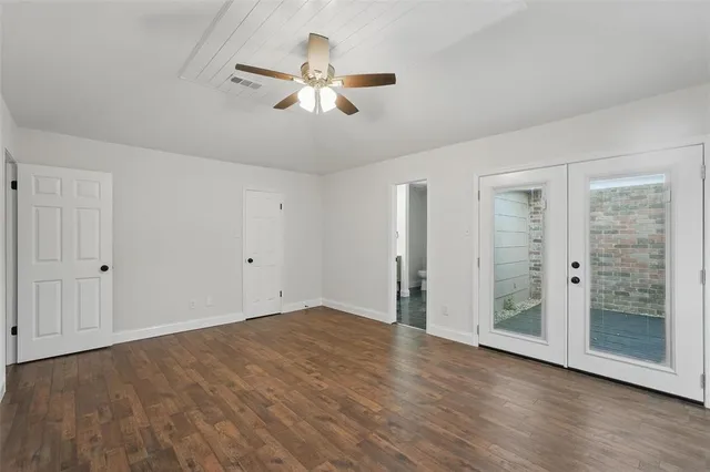 a view of an empty room with glass door