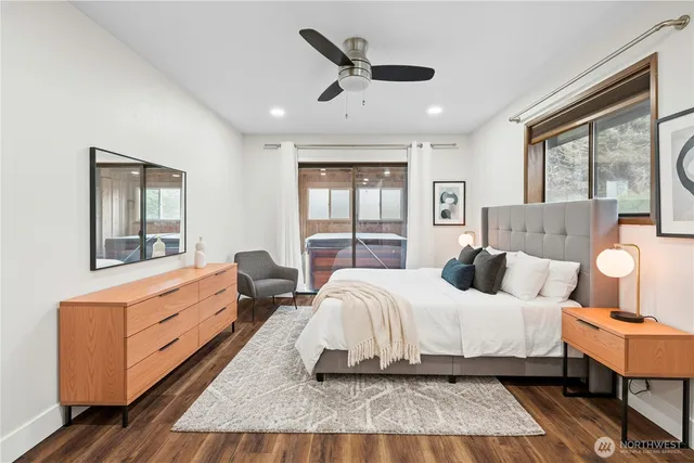 a bedroom with double bed windows and a rug