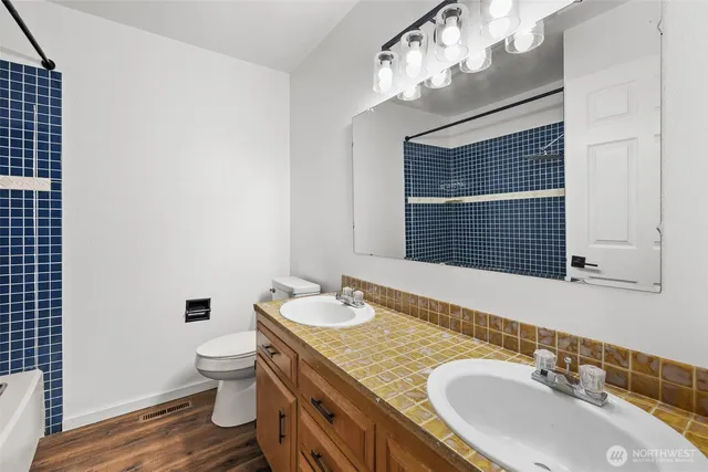 a bathroom with a granite countertop sink and a mirror