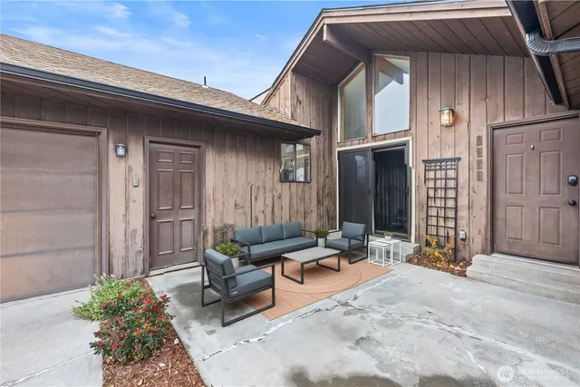 a building outdoor space with patio furniture and potted plants