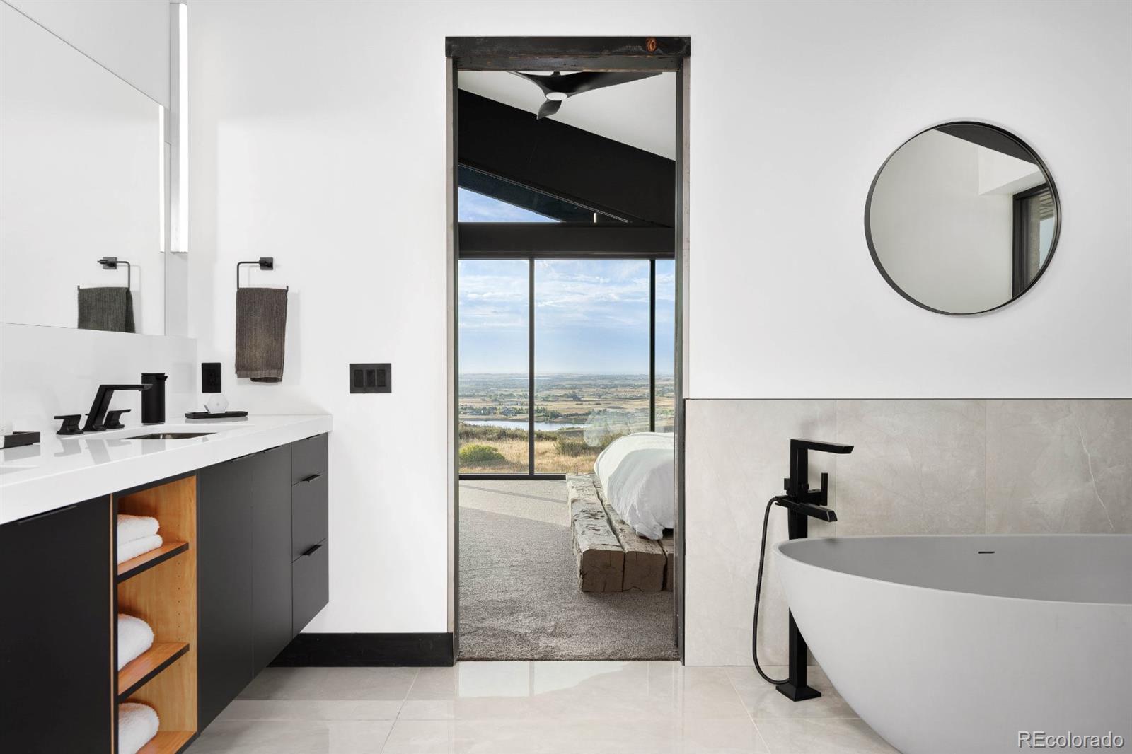 6502 Kiva Ridge Drive Berthoud, CO 80513 - Photo 37 of 50 a spacious bathroom with a tub sink and a mirror