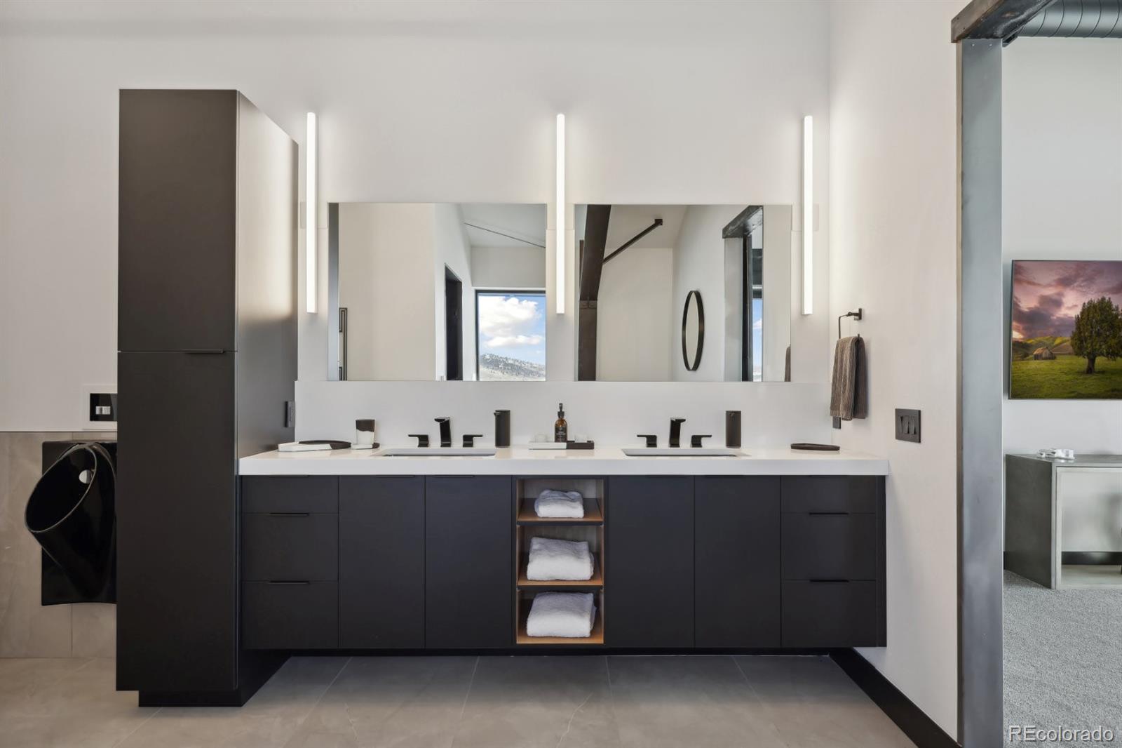 6502 Kiva Ridge Drive Berthoud, CO 80513 - Photo 40 of 50 a bathroom with a double vanity sink and mirror