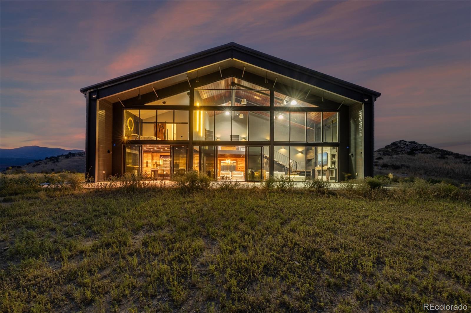 6502 Kiva Ridge Drive Berthoud, CO 80513 - Photo 4 of 50 a view of a big room with floor to ceiling windows and a yard