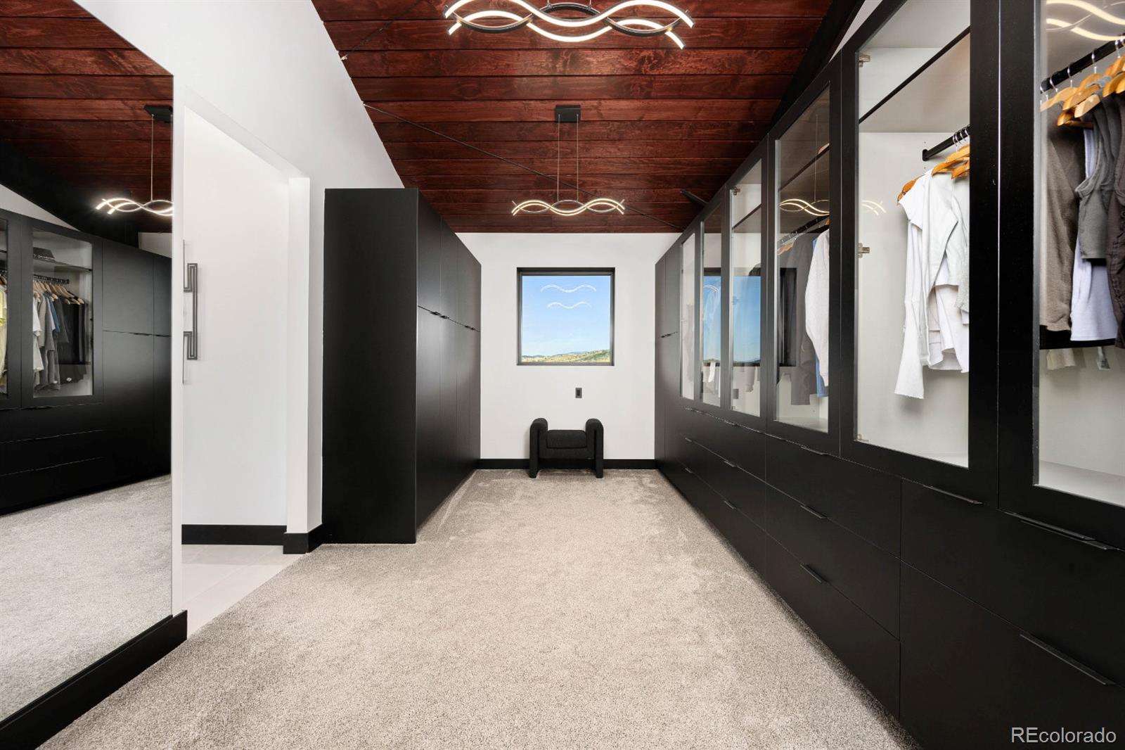 6502 Kiva Ridge Drive Berthoud, CO 80513 - Photo 41 of 50 a view of a hallway with wooden floor and a living room