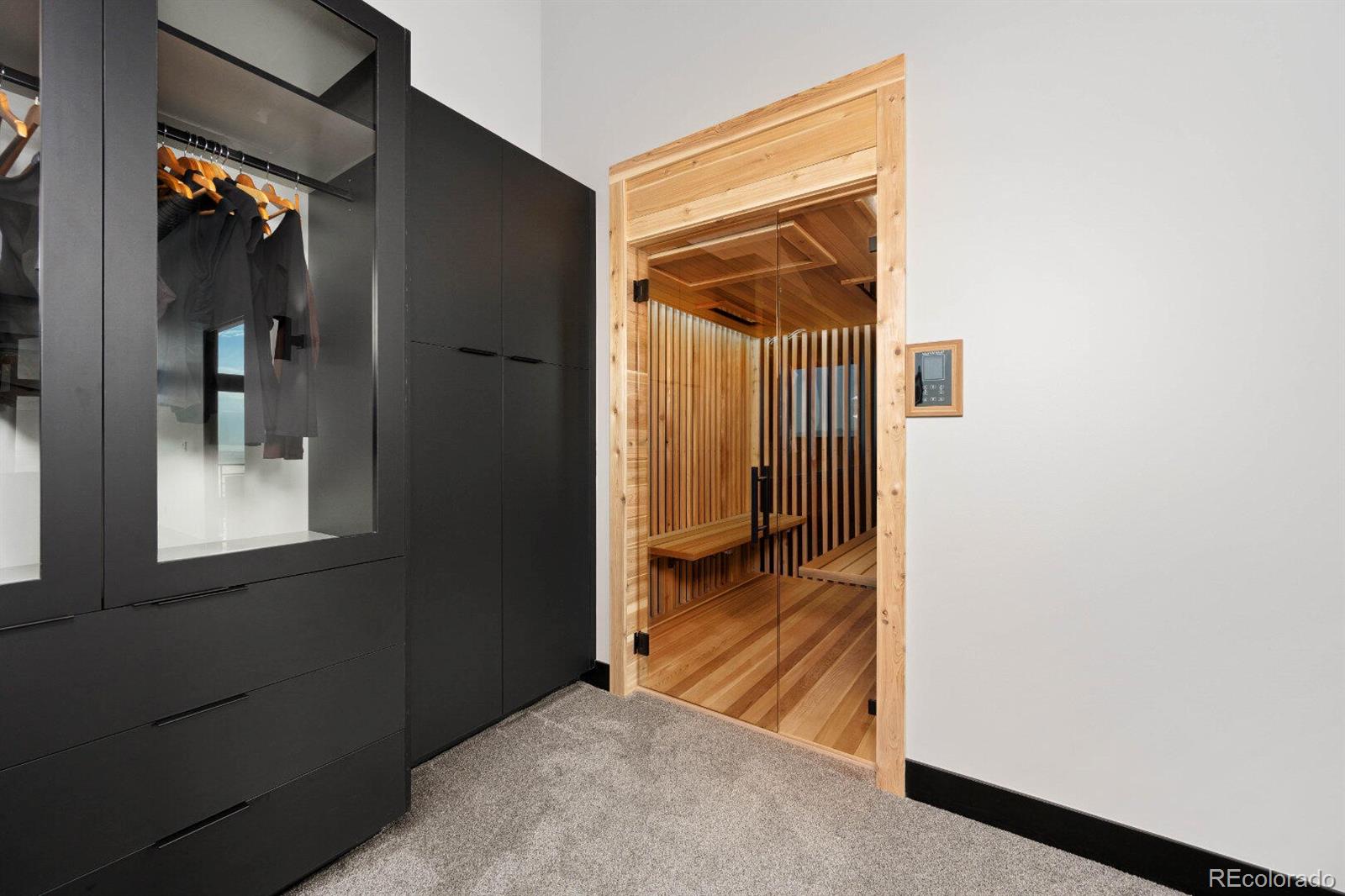 6502 Kiva Ridge Drive Berthoud, CO 80513 - Photo 42 of 50 a view of a hallway with wooden floor and a bathroom