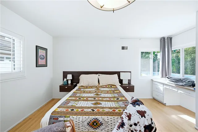 a bed sitting in a bedroom next to a window