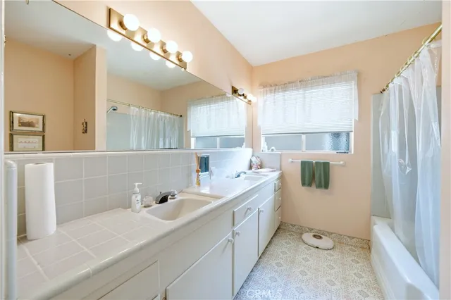 a room with a sink cabinets and a window
