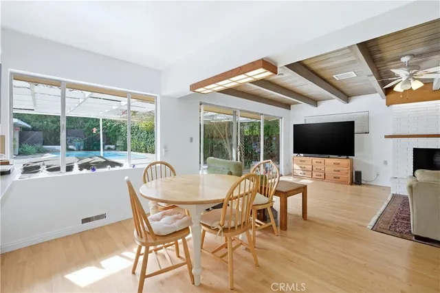 a living room with furniture a flat screen tv and a large window