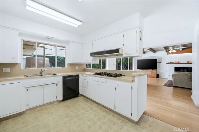a kitchen with a sink and a stove top oven
