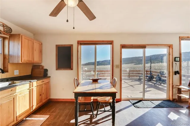 a kitchen with a table chairs refrigerator and cabinets