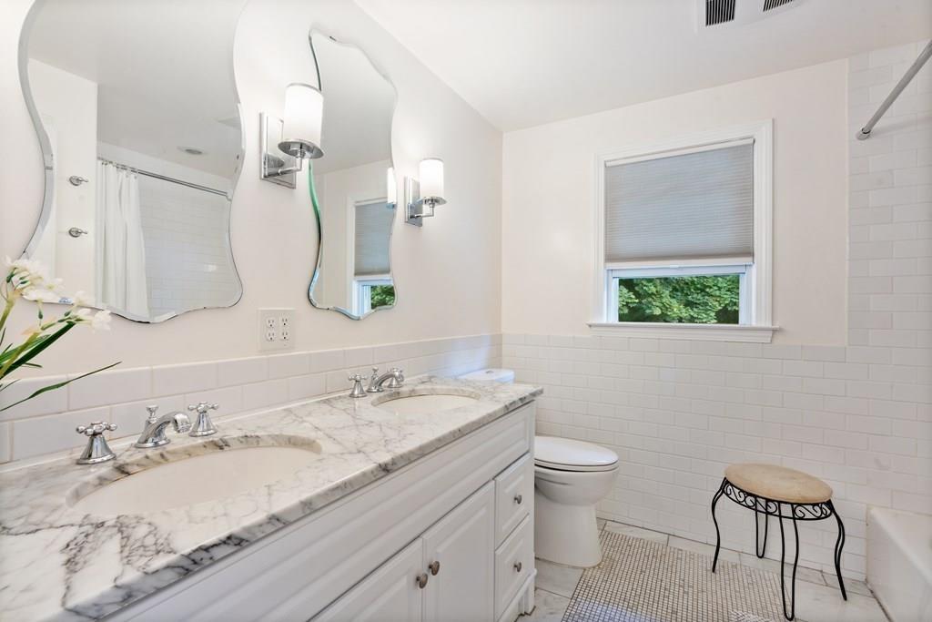 36 Intervale Road Waltham, MA 02453 - Photo 16 of 38 a bathroom with a granite countertop sink a toilet and a mirror