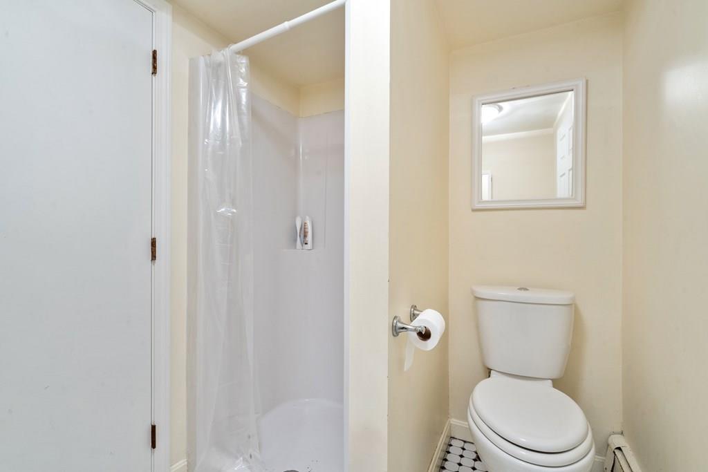 36 Intervale Road Waltham, MA 02453 - Photo 19 of 38 a white toilet sitting next to a bathroom sink