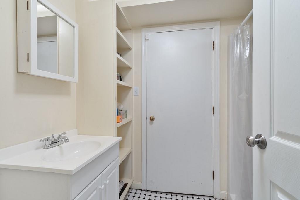 36 Intervale Road Waltham, MA 02453 - Photo 20 of 38 a bathroom with a sink vanity and mirror