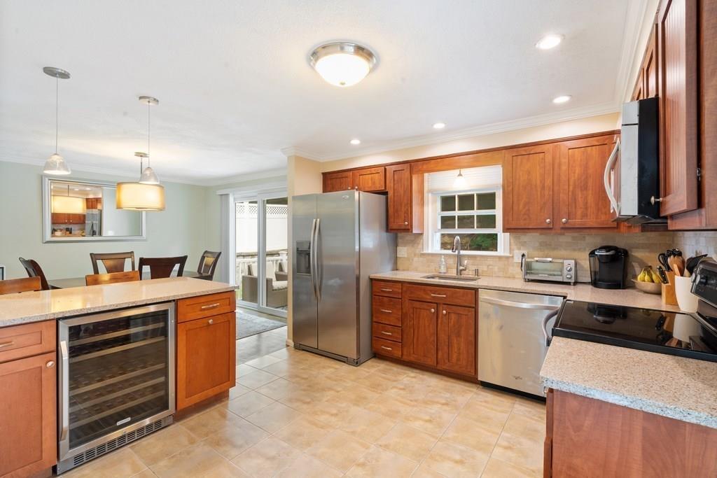 36 Intervale Road Waltham, MA 02453 - Photo 2 of 38 a kitchen with stainless steel appliances granite countertop a stove refrigerator sink and cabinets