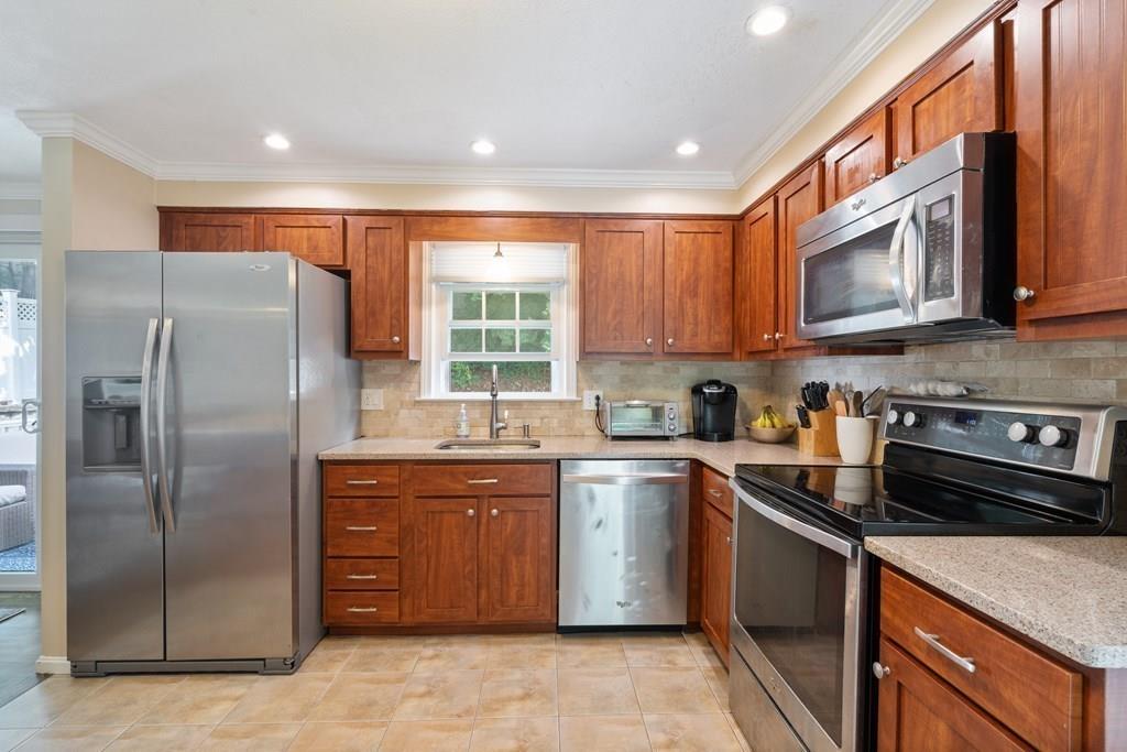 36 Intervale Road Waltham, MA 02453 - Photo 3 of 38 a kitchen with stainless steel appliances granite countertop a stove a sink a refrigerator and cabinets