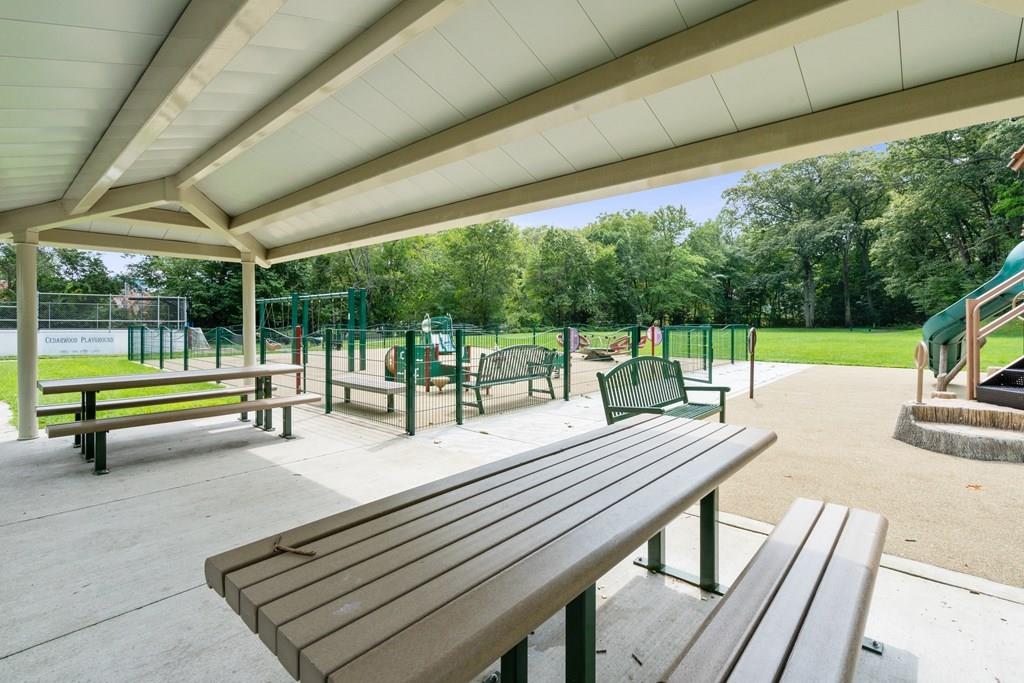 36 Intervale Road Waltham, MA 02453 - Photo 32 of 38 a view of a patio with a table chairs and a backyard